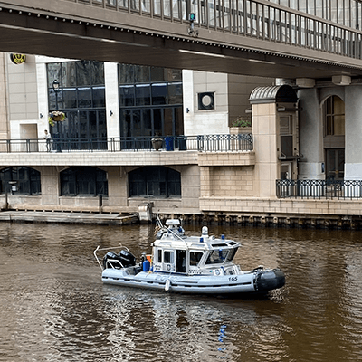 A police boat patrols the river in downtown Milwaukee.